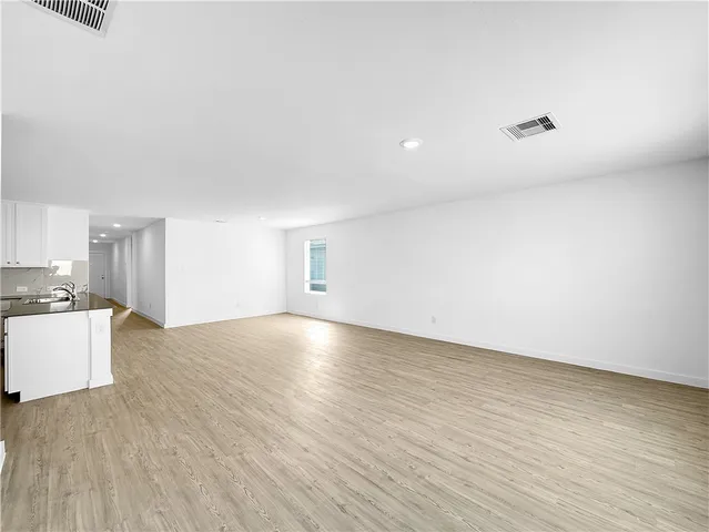 a view of a kitchen with a sink and a refrigerator