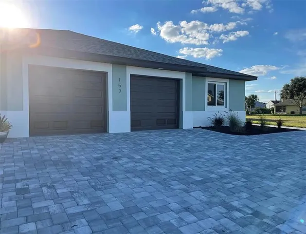 a view of a house with backyard and porch
