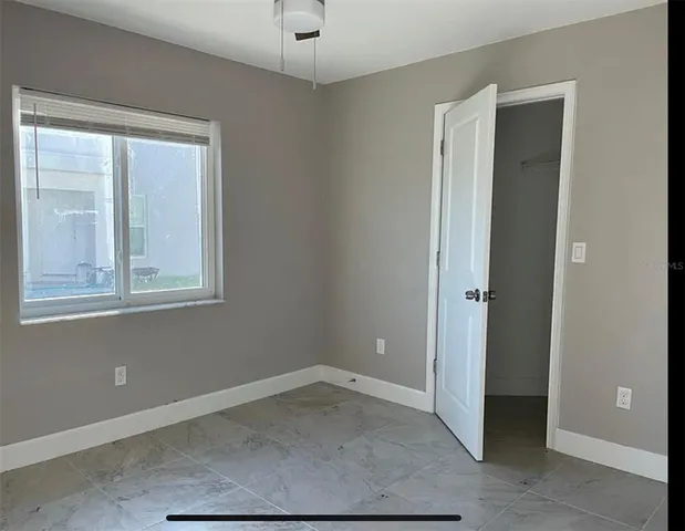 a bathroom with a granite countertop sink a toilet and shower