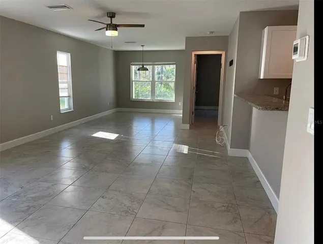 a kitchen with a sink a refrigerator and cabinets