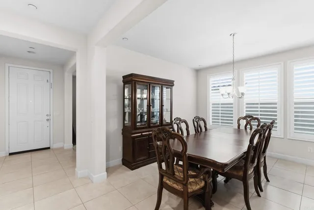 a view of a dining room and livingroom with furniture window and wooden floor