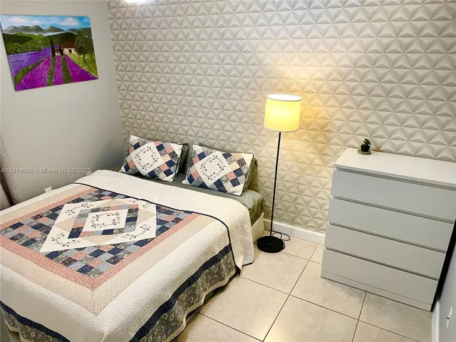 a bedroom with a bed and a table