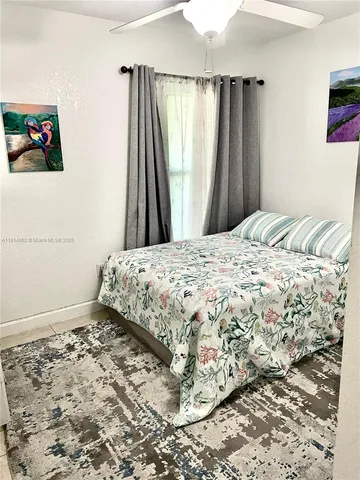 a bedroom with a bed and a mirror