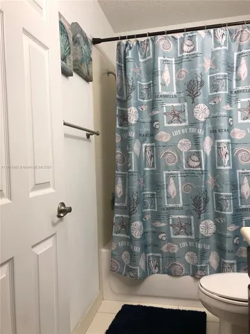 a bathroom with a shower curtain