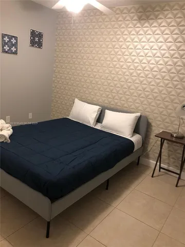 a bed sitting in a bedroom next to a wall