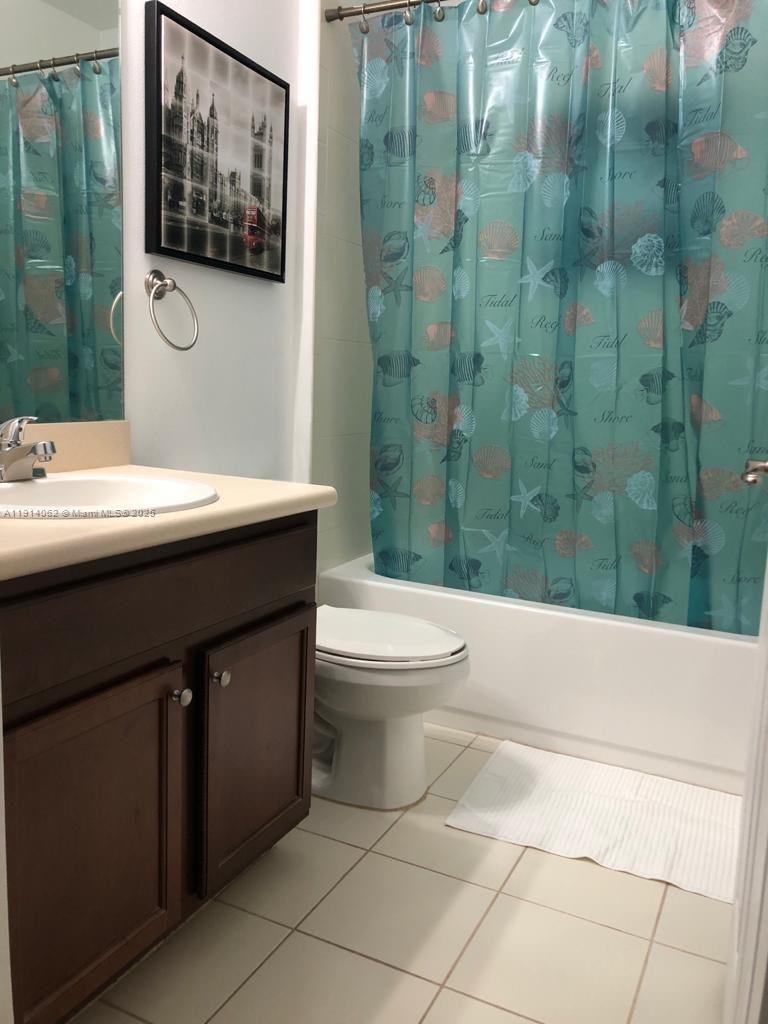 1018 Foster Road Hallandale Beach, FL 33009 - Photo 9 of 13 a bathroom with a sink a toilet and shower