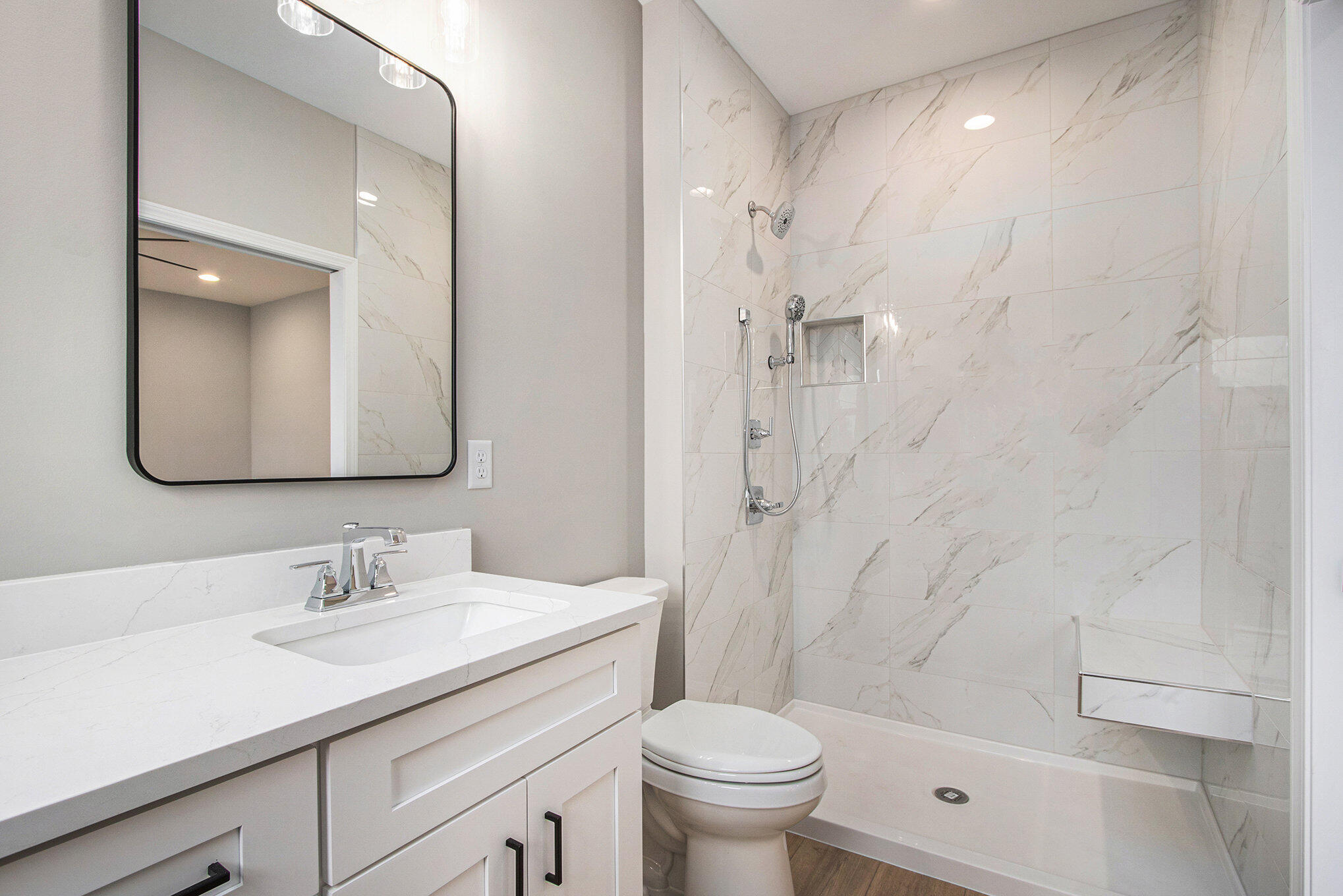 5766 Brookview Avenue Portage, IN 46368 - Photo 11 of 18 a bathroom with a granite countertop sink a toilet and shower