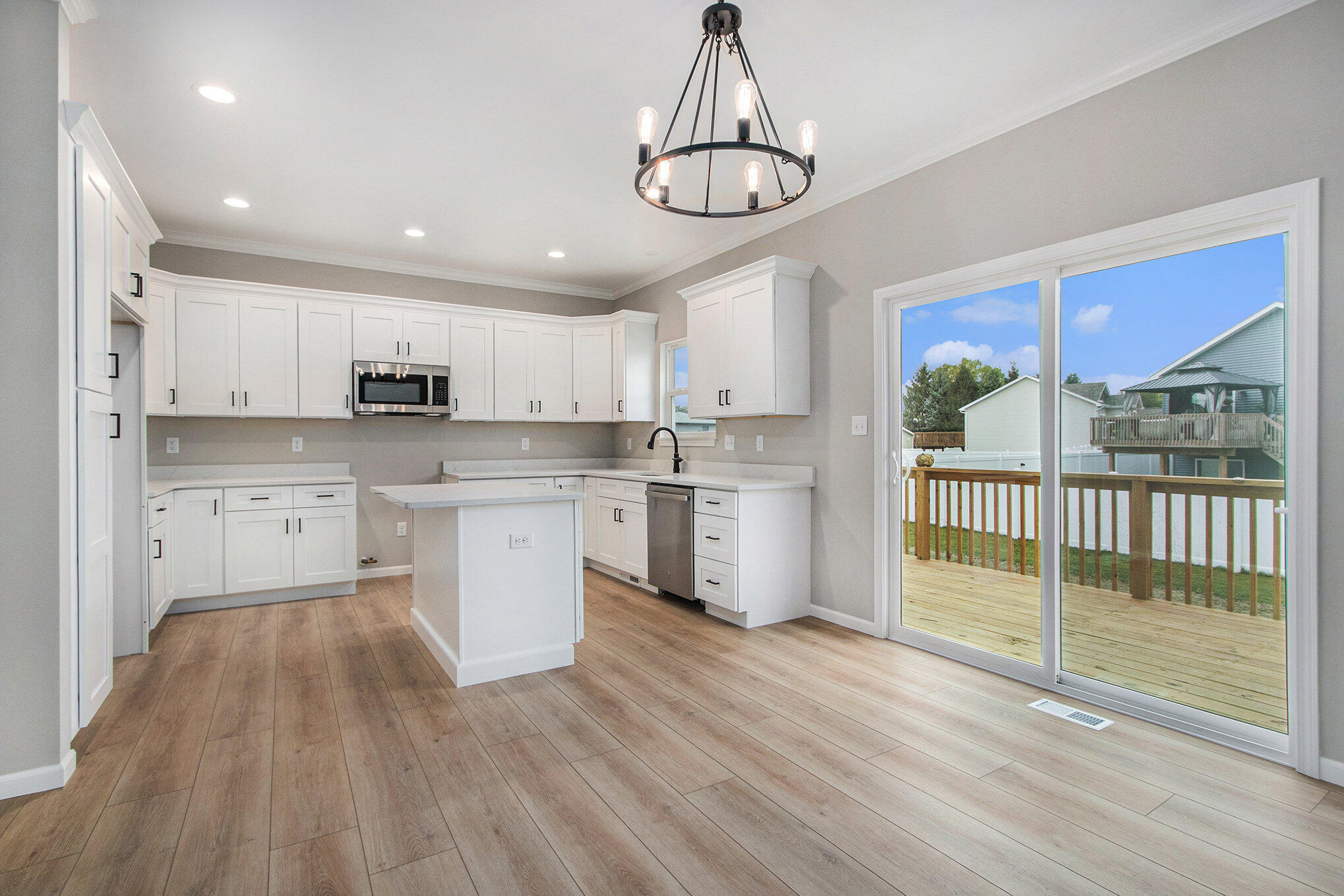 5766 Brookview Avenue Portage, IN 46368 - Photo 6 of 18 a kitchen with stainless steel appliances a window and wooden cabinets
