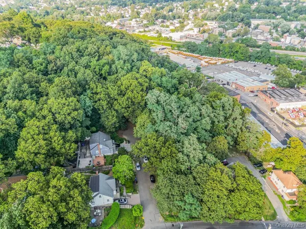 an aerial view of a house with garden space and street view