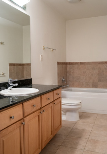 847 West Monroe Street, Unit 3F Chicago, IL 60607 - Photo 3 of 7 a bathroom with a granite countertop sink a toilet and bathtub