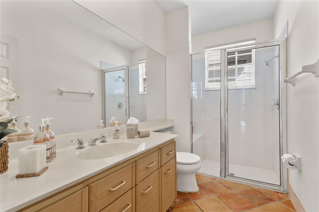 8170 Hampton Wood Drive Boca Raton, FL 33433 - Photo 15 of 21 a bathroom with a double vanity sink toilet and shower