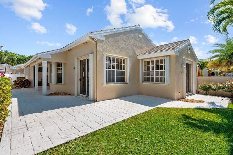 8170 Hampton Wood Drive Boca Raton, FL 33433 - Photo 17 of 21 a view of a house with a yard and potted plants