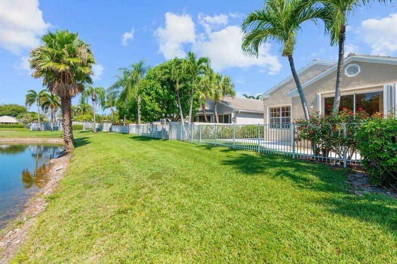 8170 Hampton Wood Drive Boca Raton, FL 33433 - Photo 19 of 21 a front view of a house with garden and trees