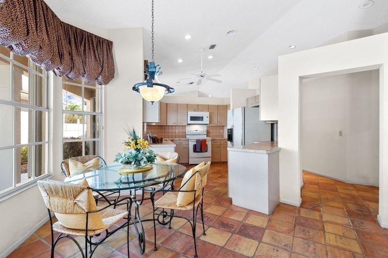 8170 Hampton Wood Drive Boca Raton, FL 33433 - Photo 6 of 21 a dining room with furniture and chandelier