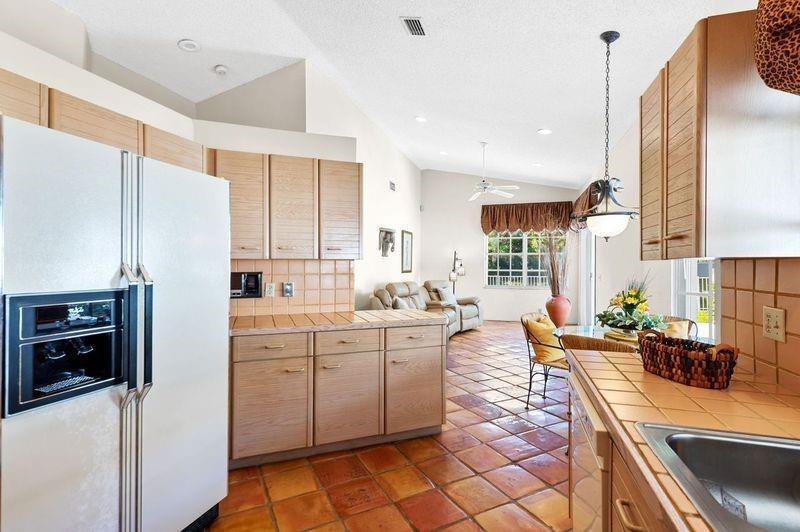 8170 Hampton Wood Drive Boca Raton, FL 33433 - Photo 7 of 21 a large kitchen with kitchen island a sink stainless steel appliances and cabinets