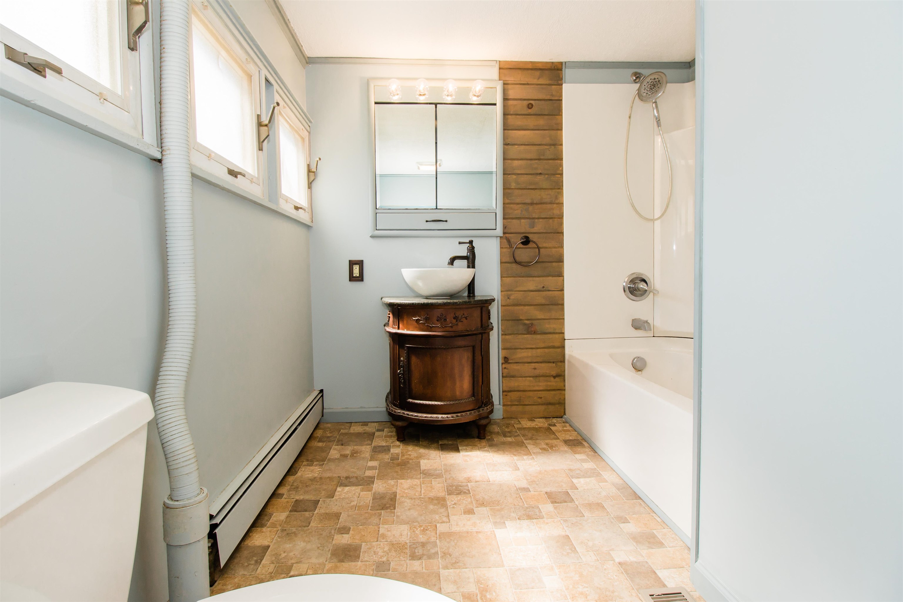 409 Bruce Street Bridgewater, VA 22812 - Photo 11 of 29 a bathroom with a granite countertop sink a toilet and a shower