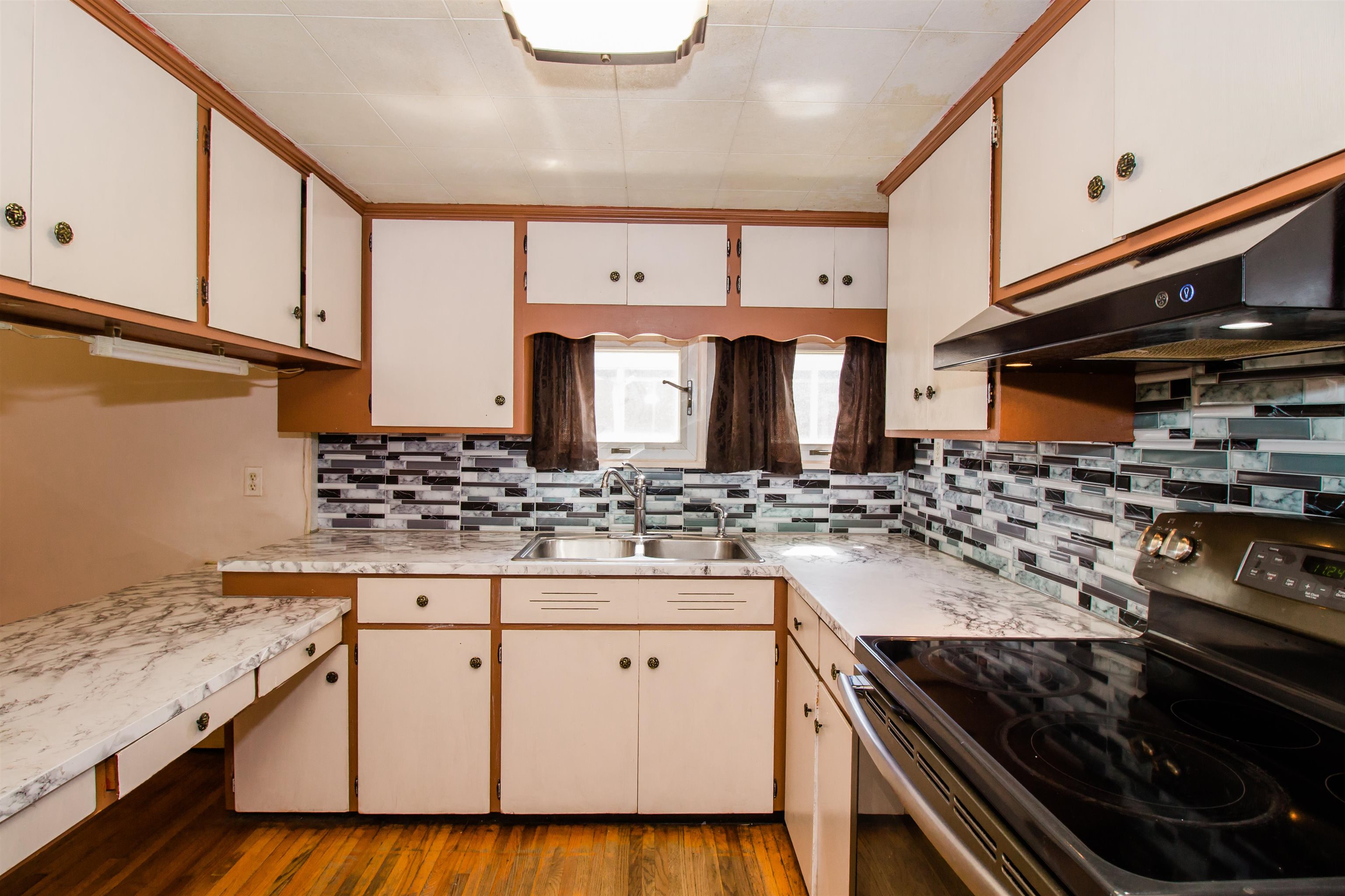 409 Bruce Street Bridgewater, VA 22812 - Photo 17 of 29 a kitchen with stainless steel appliances granite countertop a stove and a sink