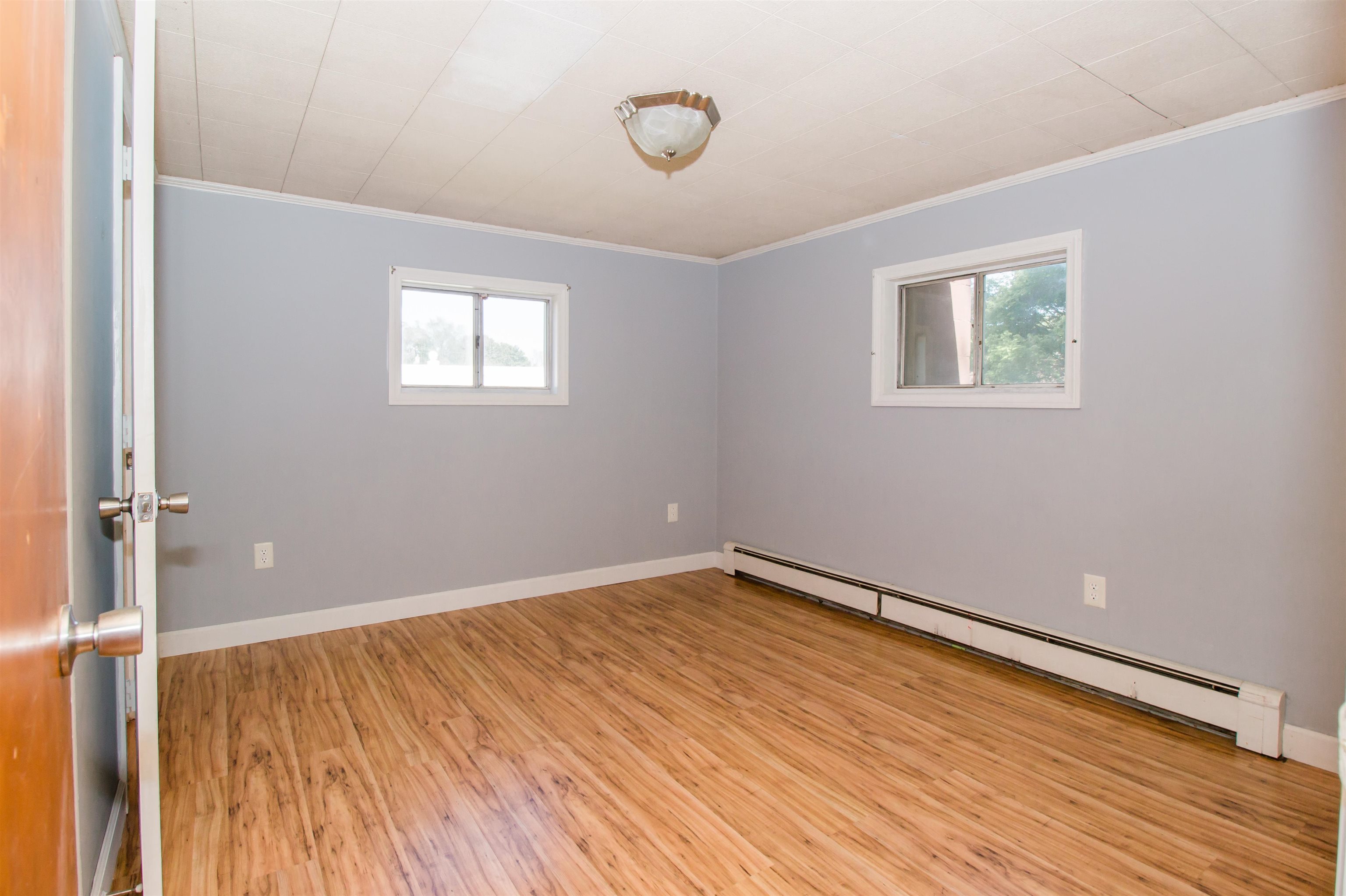 409 Bruce Street Bridgewater, VA 22812 - Photo 19 of 29 an empty room with wooden floor and windows