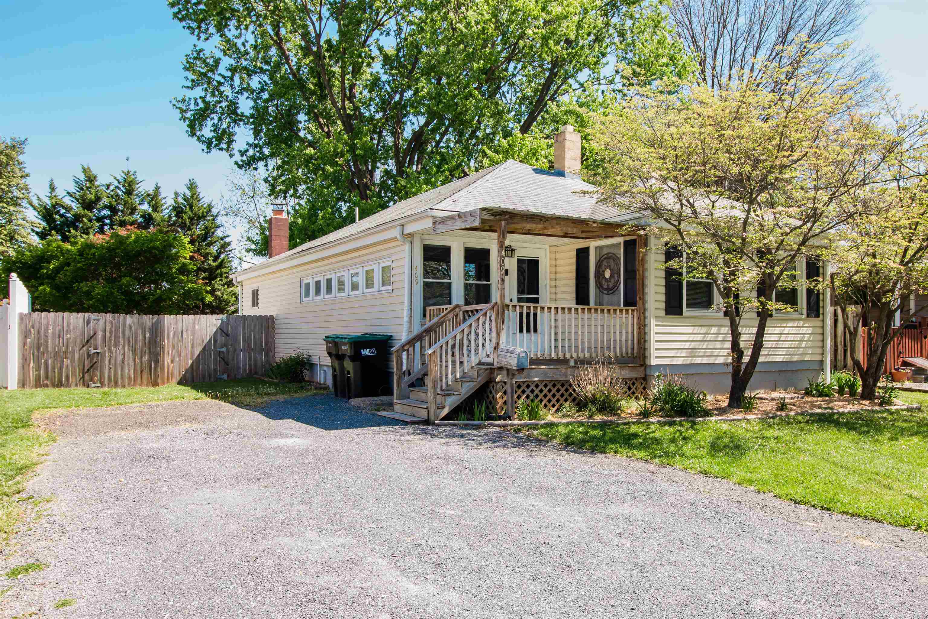409 Bruce Street Bridgewater, VA 22812 - Photo 3 of 29 a front view of a house with a yard and garage