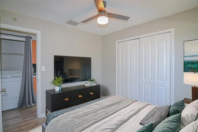 a bedroom with a bed and a flat screen tv