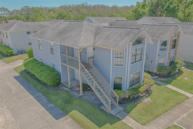 an aerial view of a house with a yard