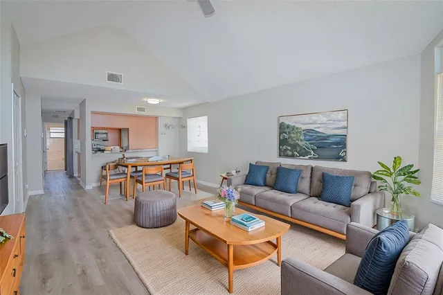 a living room with furniture and wooden floor