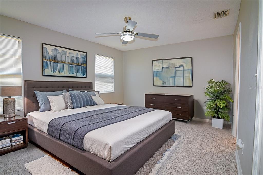 2742 Rio Grande Trail Kissimmee, FL 34741 - Photo 6 of 18 a bedroom with bed and a chandelier