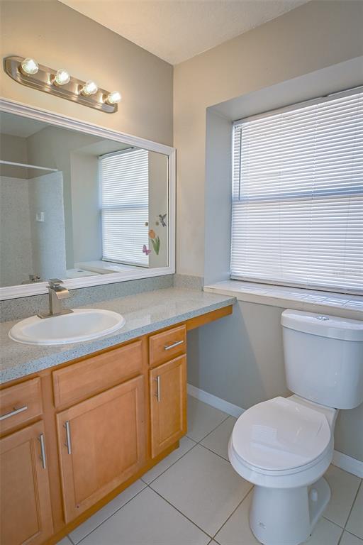 2742 Rio Grande Trail Kissimmee, FL 34741 - Photo 7 of 18 a bathroom with a granite countertop toilet sink and mirror