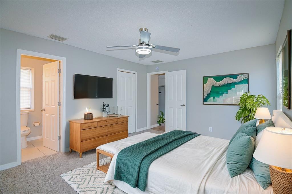 2742 Rio Grande Trail Kissimmee, FL 34741 - Photo 8 of 18 a bedroom with a bed and a flat screen tv