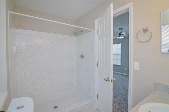 a bathroom with a shower and toilet