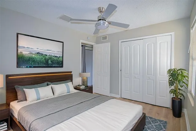 a bedroom with a large bed and a chandelier