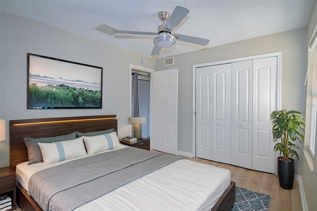 2742 Rio Grande Trail Kissimmee, FL 34741 - Photo 10 of 18 a bedroom with a large bed and a chandelier