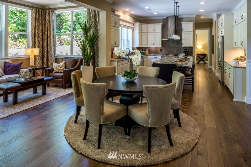 5629 196th Street Southeast, Unit 32 Bothell, WA 98012 - Photo 16 of 25 a dining room with furniture a large window and wooden floor