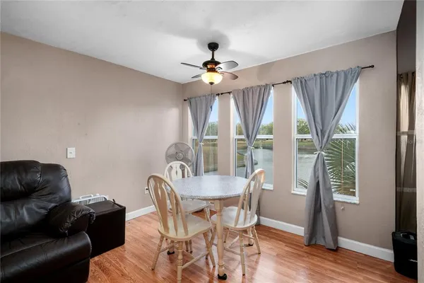a dining room with furniture a chandelier and wooden floor
