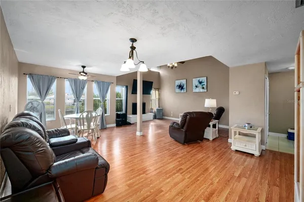 a living room with furniture and wooden floor