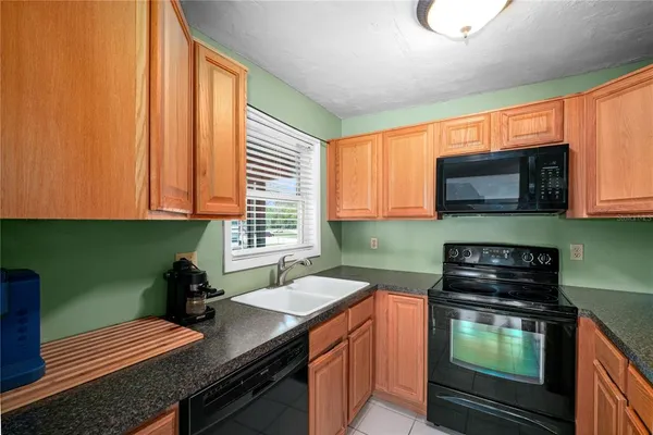 a kitchen with a stove a sink and a microwave