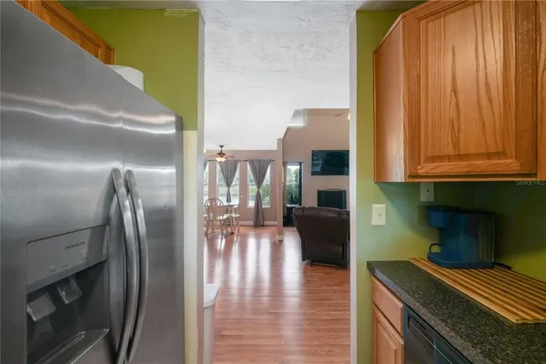 a kitchen with stainless steel appliances granite countertop a refrigerator and a stove top oven
