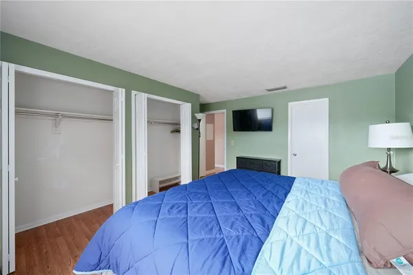 a bedroom with a bed and a flat screen tv