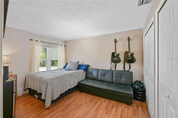 a bedroom with a bed and window