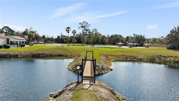 a view of swimming pool with outdoor seating and lake view