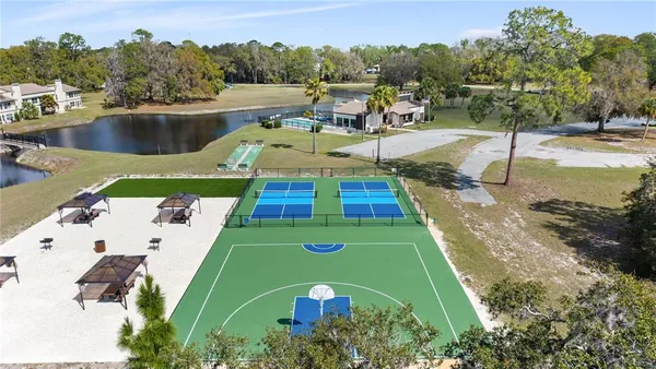 an aerial view of a swimming pool with a yard
