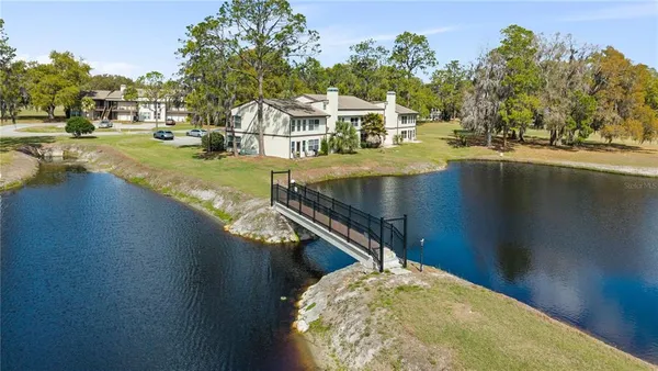 a view of swimming pool with outdoor seating and lake view