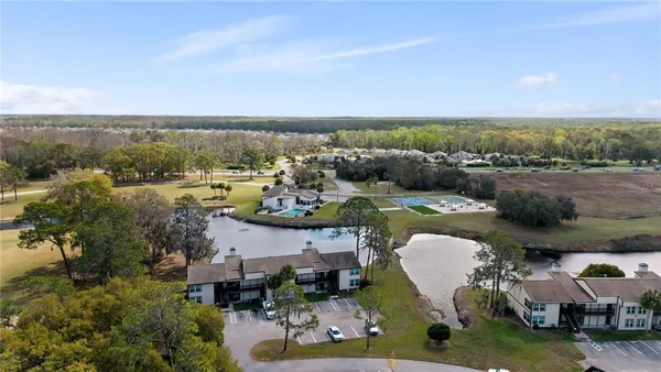 an aerial view of a house with yard swimming pool and outdoor seating