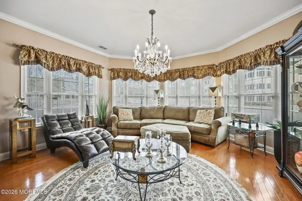 a living room with furniture and a chandelier