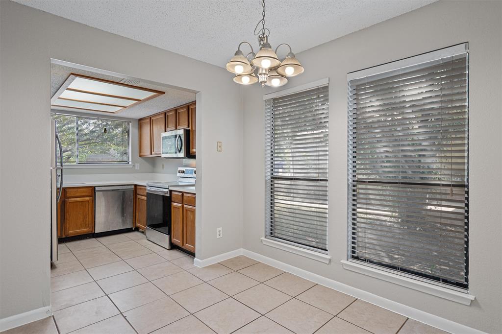 13357 Water Oak Lane, Unit B Austin, TX 78729 - Photo 1 of 26 a kitchen with stainless steel appliances granite countertop a stove a sink and a microwave