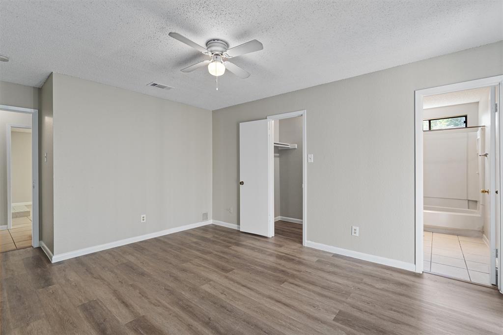 13357 Water Oak Lane, Unit B Austin, TX 78729 - Photo 14 of 26 a view of an empty room with wooden floor