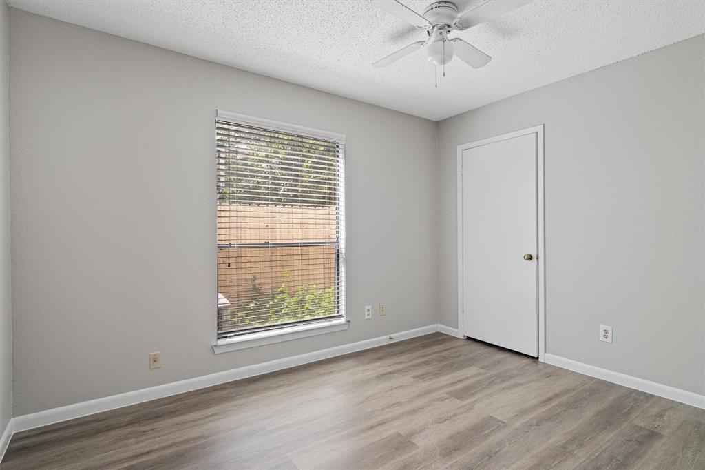 13357 Water Oak Lane, Unit B Austin, TX 78729 - Photo 17 of 26 an empty room with a window and a ceiling fan