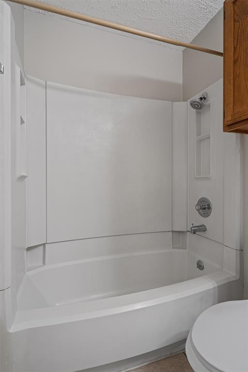 13357 Water Oak Lane, Unit B Austin, TX 78729 - Photo 20 of 26 a bathroom with a bathtub and a toilet