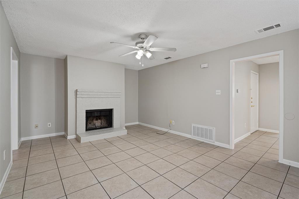 13357 Water Oak Lane, Unit B Austin, TX 78729 - Photo 5 of 26 a view of an empty room with a fireplace