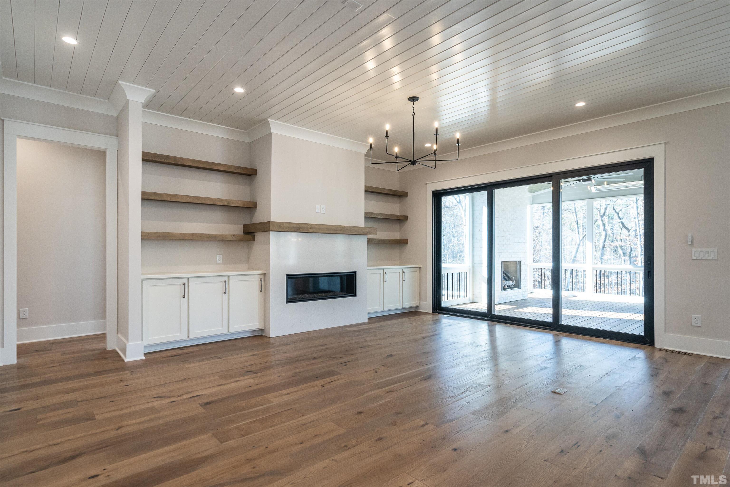 5425 Winding View Lane Raleigh, NC 27615 - Photo 11 of 54 a view of a room with wooden floors and fireplace